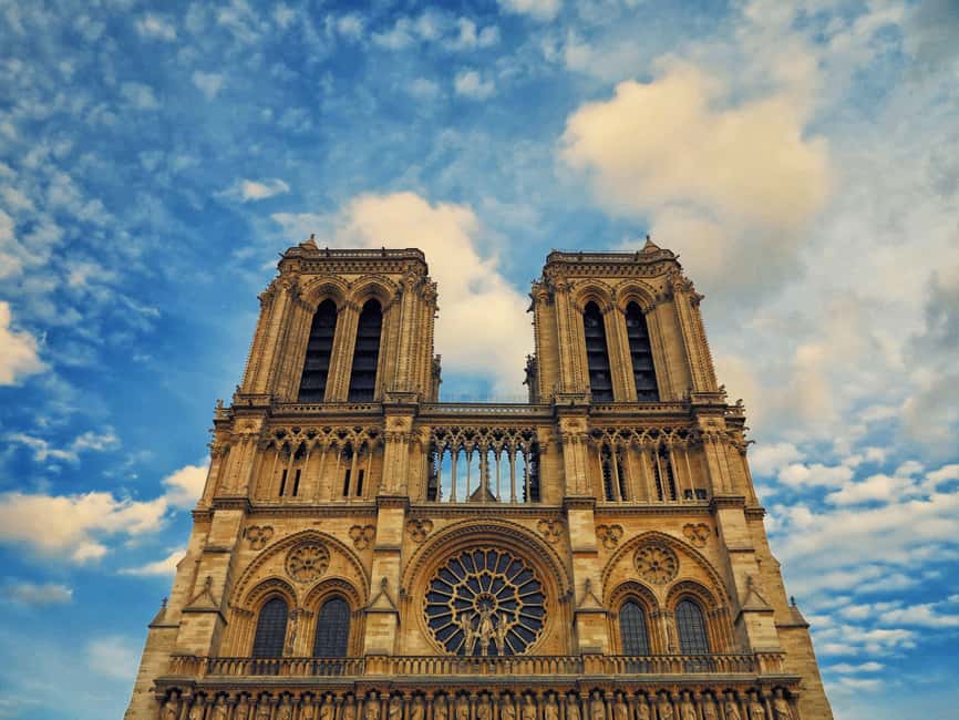 Paris: Île de la Cité and Notre-Dame Walking Tour With Crypt - Notre-Dame clues outside: symbols, the façade, and the oldest clock